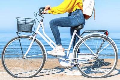 Low section of person riding bicycle on city street