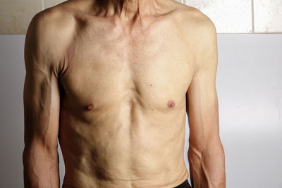 Midsection of shirtless man
