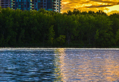 Scenic view of lake against sky at sunset