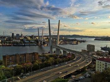 High angle view of city by sea against sky