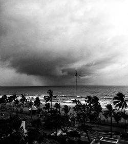 Group of people on beach against sky