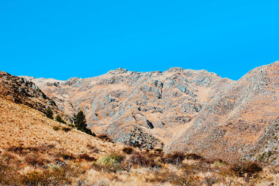 Scenic view of mountains against clear blue sky