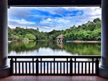 Scenic view of lake by building against sky