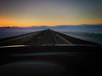 Road against clear sky at night