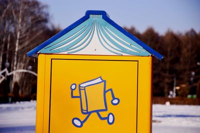 Close-up of yellow sign on snow