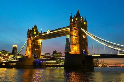 Low angle view of illuminated bridge against sky at night