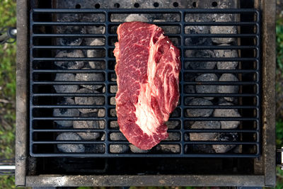High angle view of meat on barbecue grill