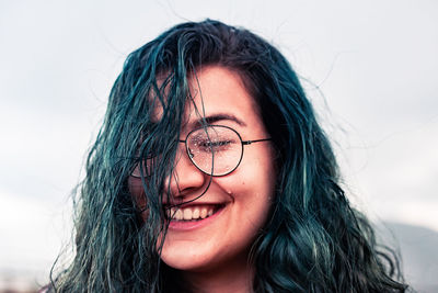 Close-up portrait of smiling young woman