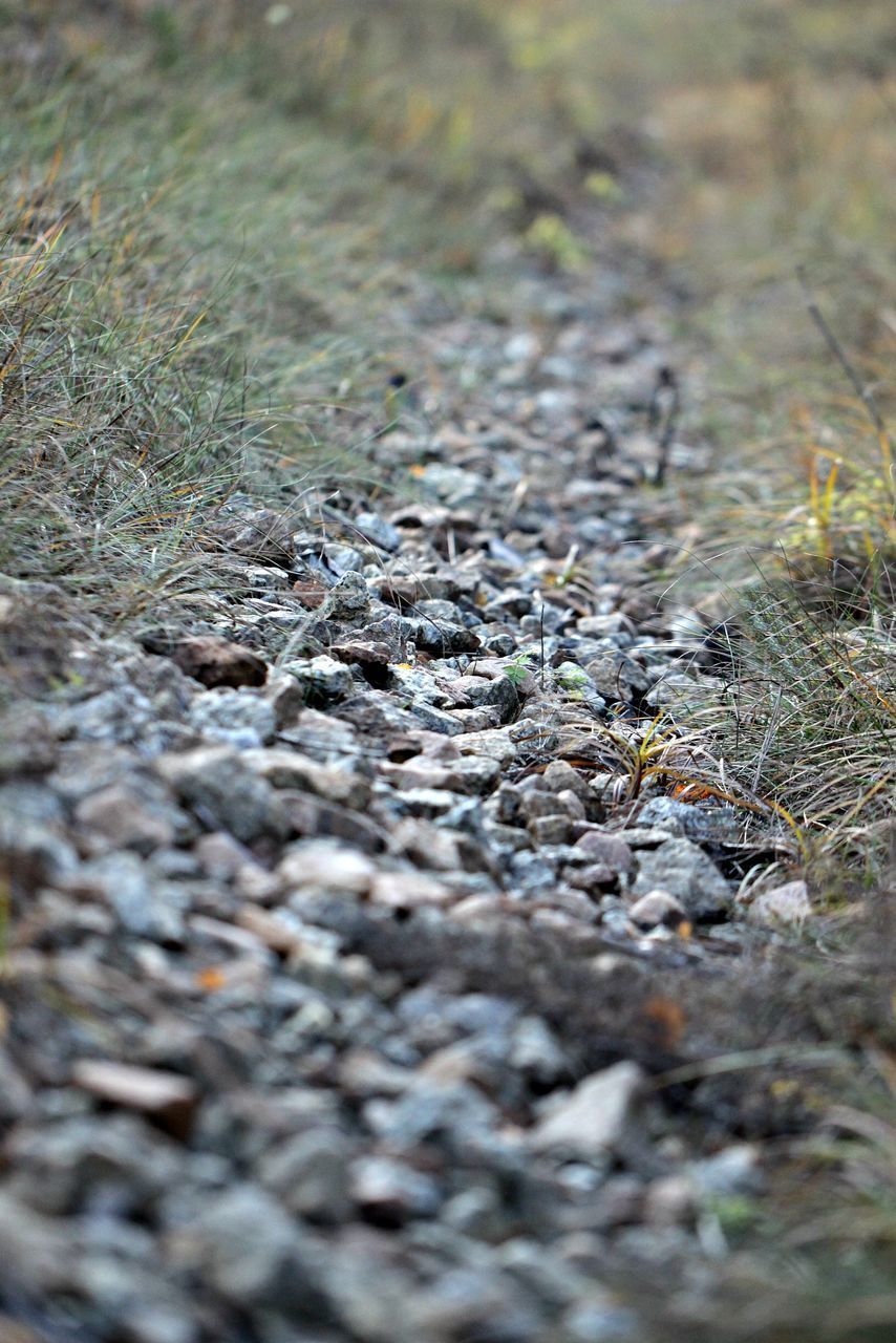 HIGH ANGLE VIEW OF STONES ON LAND