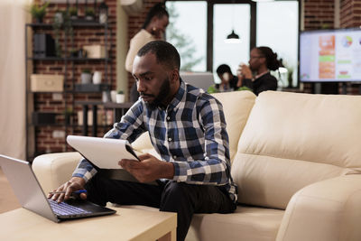 Young woman using laptop at home