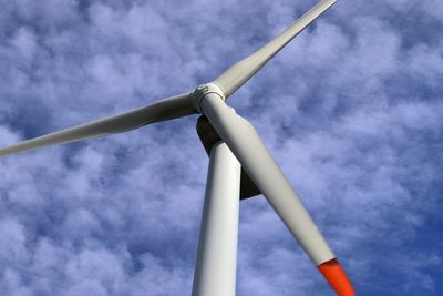 Low angle view of wind turbine against sky