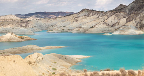 Scenic view of lake and mountains against sky