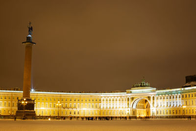 Illuminated building against clear sky at night