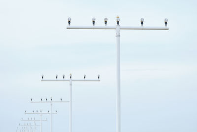 Low angle view of birds perching on the sky