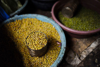 High angle view of legumes and glass in container