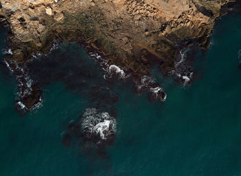 High angle view of rock formation in sea