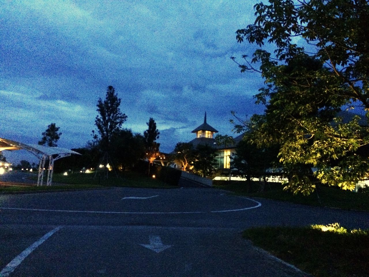 tree, architecture, built structure, illuminated, building exterior, sky, the way forward, street light, night, road, lighting equipment, street, diminishing perspective, travel destinations, city, outdoors, religion, blue, no people