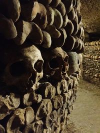 Close-up of human skull on stone wall in temple