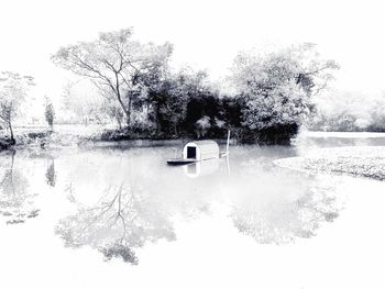 Scenic view of lake against snow during winter