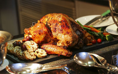 Close-up of roasted chicken on slate