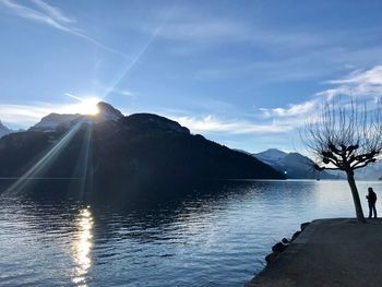 Scenic view of lake and mountains against sky