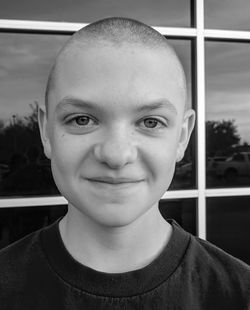 Close-up black and white portrait of smiling boy