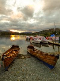 Boats moored on beach against sky