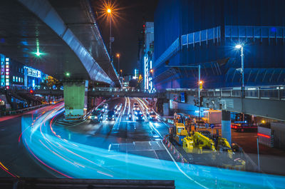 Illuminated light trails on street in city at night