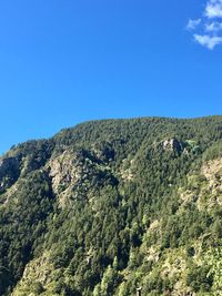 Scenic view of mountains against clear blue sky