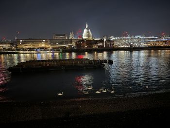 Illuminated city at waterfront