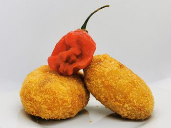 Close-up of orange fruit against white background