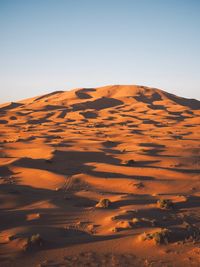 Scenic view of desert against sky during sunset