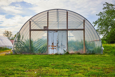 Built structure on field against sky