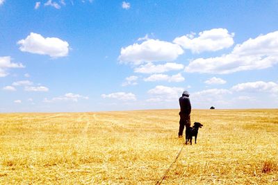 Full length of man standing on field against sky