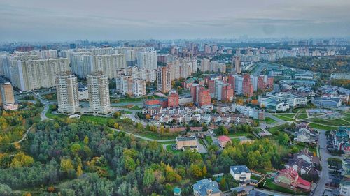 High angle view of modern buildings in city against sky