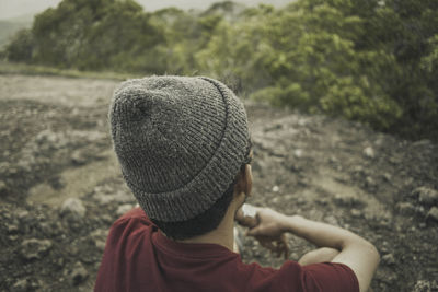 Rear view of man wearing hat on field