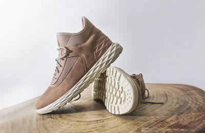 A pair of brown leather waterproof trekking boots on a wooden background. hiking concept.