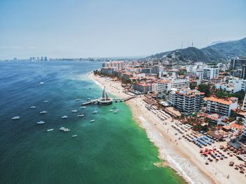 High angle view of sea and buildings against sky