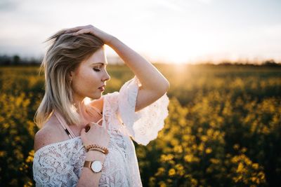 Young woman standing on field