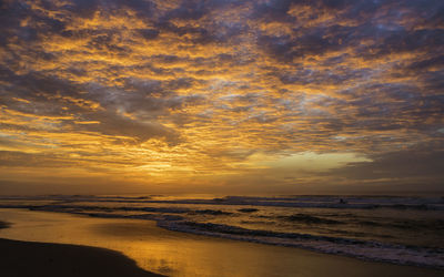 Scenic view of beach against sky during sunset