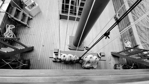 High angle view of ropes hanging on railing