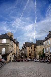 Panoramic view of buildings in town against sky