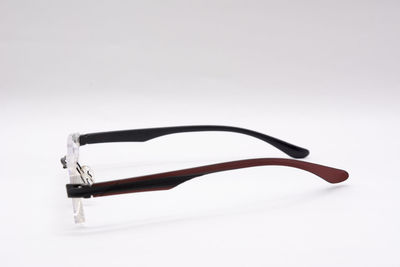 High angle view of eyeglasses on table against white background