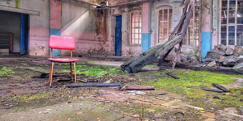 Abandoned chair outside house