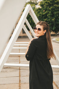 Portrait of smiling young woman standing outdoors