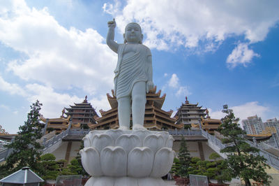 Low angle view of statue against cloudy sky