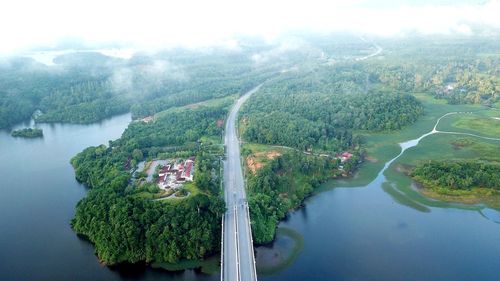 High angle view of river amidst trees against sky