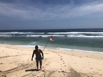 Full length of man on beach against sky