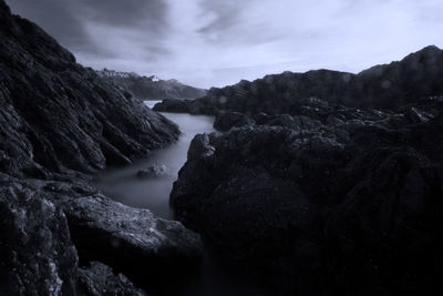 Scenic view of rocks in mountains against sky