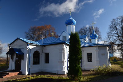 Church by building against sky